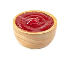 tomato sauce in wooden bowl isolated on white background photo