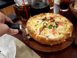 pizza de marisco en mesa de madera foto