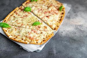 Flammkuchen savory pie bacon, onion, sour cream pastrie meal food snack on the table copy space food background photo