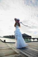 asian bride on beach photo