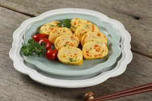 Tamagoyaki or Japanses Egg Roll. Gyeran Mari or Korean Rolled Omelette photo