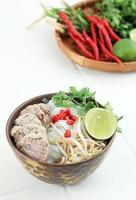 Pho Bo Soup with Beef, Rice Noodles, Lime, Chili Pepper, amd Sprout in Bwon Bowl on White Background. photo