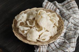 Krupuk Upil or Krupuk Mlarat, Indonesian Popular Cracker made from Cassava Flour and Fried without Oil. Mlarat Means Poor because Have no Oil to Cook photo
