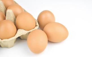 Fresh and appetizing eggs are packed in egg cartons. put on a white background photo