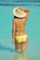 asian woman resting on sand at beach photo