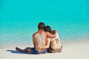 happy young  couple enjoying summer on beach photo