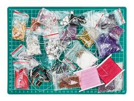 various embroidery items on cutting mat isolated photo