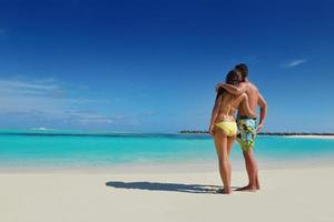 happy young  couple enjoying summer on beach photo