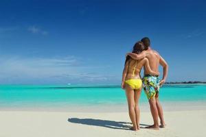 happy young  couple enjoying summer on beach photo