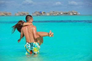 happy young  couple enjoying summer on beach photo