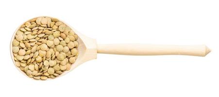 top view of wood spoon with light green lentils photo