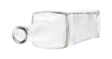 overturned empty clear wine bottle isolated photo