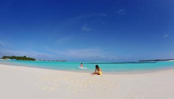 happy young  couple enjoying summer on beach photo