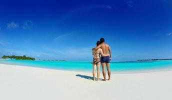 happy young  couple enjoying summer on beach photo