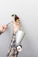man disassembles defected ceiling lamp photo