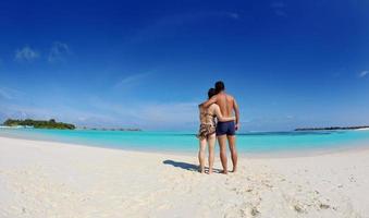 asian couple enjoying summer on beach photo