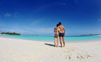 asian couple enjoying summer on beach photo