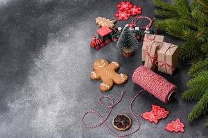 Gingerbread, Christmas tree decorations, dried citrus fruits on a gray concrete background photo