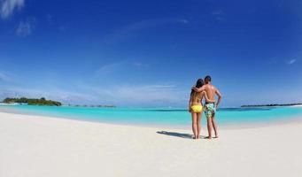 happy young  couple enjoying summer on beach photo
