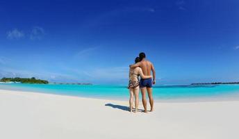 happy young  couple enjoying summer on beach photo