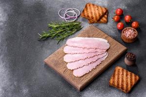Sliced ham on wooden background. Fresh prosciutto. Pork ham sliced photo