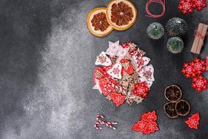 Gingerbread, Christmas tree decorations, dried citrus fruits on a gray concrete background photo