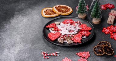 Gingerbread, Christmas tree decorations, dried citrus fruits on a gray concrete background photo