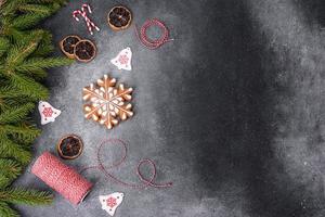 Gingerbread, Christmas tree decorations, dried citrus fruits on a gray concrete background photo