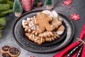 Gingerbread, Christmas tree decorations, dried citrus fruits on a gray concrete background photo