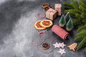 Gingerbread, Christmas tree decorations, dried citrus fruits on a gray concrete background photo