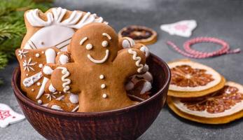 Gingerbread, Christmas tree decorations, dried citrus fruits on a gray concrete background photo