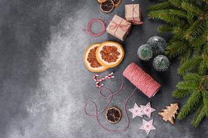 Gingerbread, Christmas tree decorations, dried citrus fruits on a gray concrete background photo