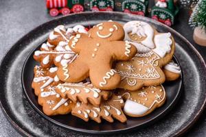 Gingerbread, Christmas tree decorations, dried citrus fruits on a gray concrete background photo