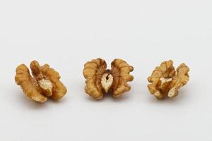 Three walnuts isolated on white background. Food texture concept photo