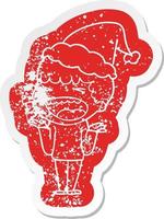 cartoon distressed sticker of a laughing man wearing santa hat vector