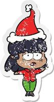 distressed sticker cartoon of a tired woman wearing santa hat vector