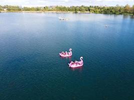 Beautiful Aerial Drone's Camera  Footage of Willen Lake and Park which is located at Milton Keynes, England. People are Enjoying at Lake on a Hot Sunny Day of Summer photo