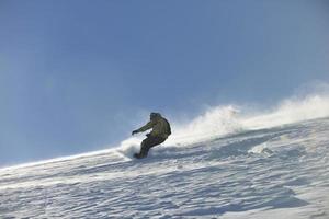 freestyle snowboarder jump and ride photo