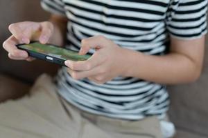 Hand kid holding smartphone for playing games photo