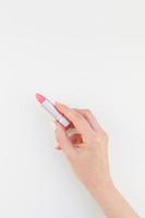 Woman hand with pink lipstick photo