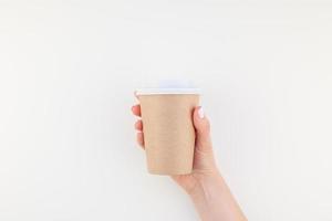 Mock up of coffee cup in female hand photo