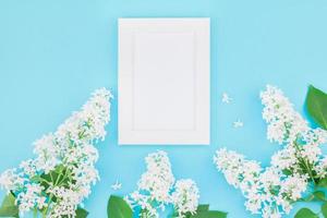 Blank frame mockup with white flowers photo