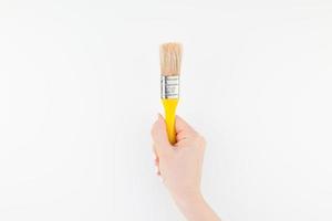 Woman hand holding new paint brush isolated photo