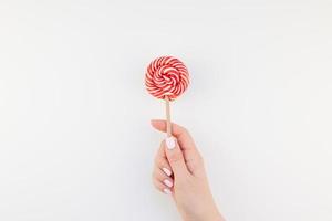 Woman hand with red lollipop photo