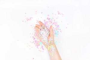 Pearl pastel confetti sparkles with woman hand photo