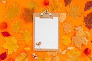 Autumn clipboard mockup with fall leaves photo