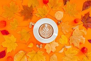 Coffee latte cup in dry autumn leaves wreath frame photo