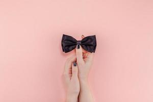 Black bow tie woman hand for men fathers concept photo