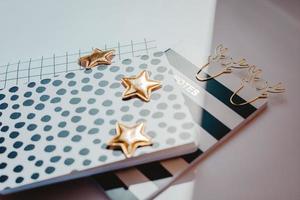 Desktop feminine composition. Notepads and stars photo