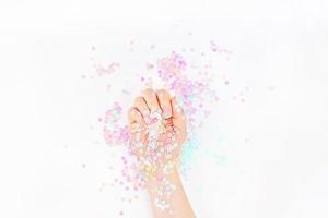 Pearl pastel confetti sparkles with woman hand photo